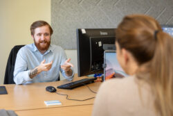 office worker smiling at his desk