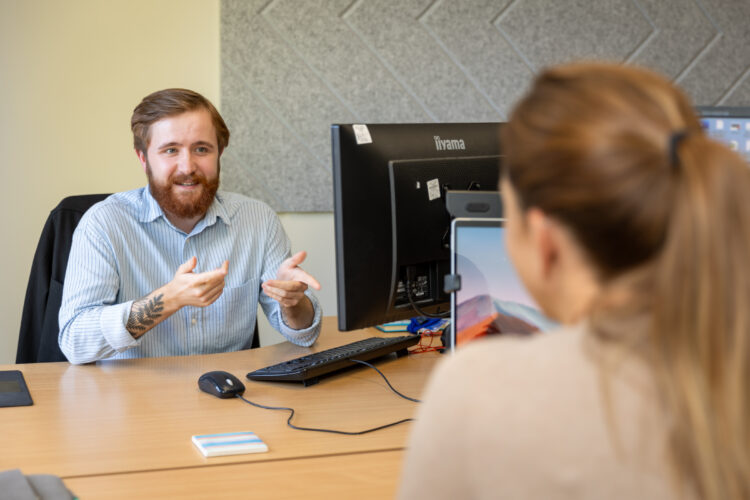 office worker smiling at his desk