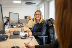 office worker smiling at her desk