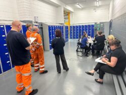 people waiting for blood pressure check in work depot