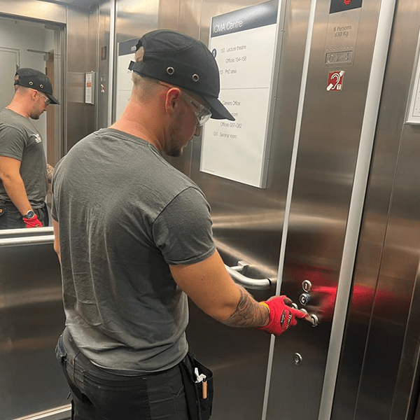 Lift Engineer checking alarm system