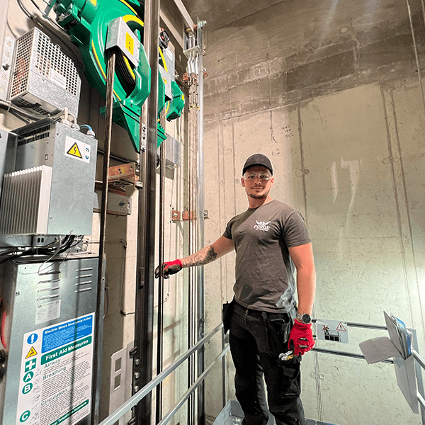 Forge Lifts lift engineer on top of a lift inside a lift shaft.