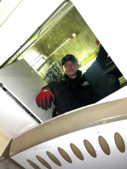 Lift engineer looking down into a passenger lift from a rescue hatch.