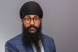 A business headshot of man wearing turban