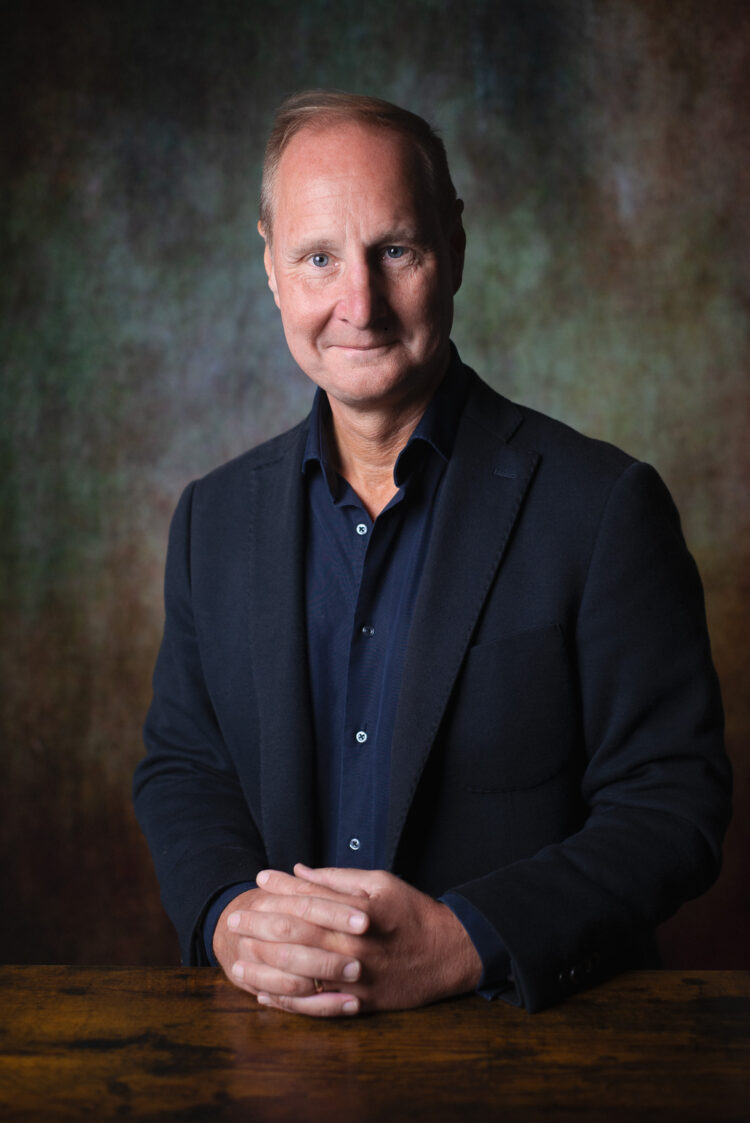 Portrait of man in blue suit smiling at camera