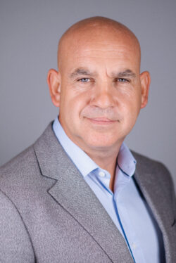 Headshot of bald businessman looking at the camera