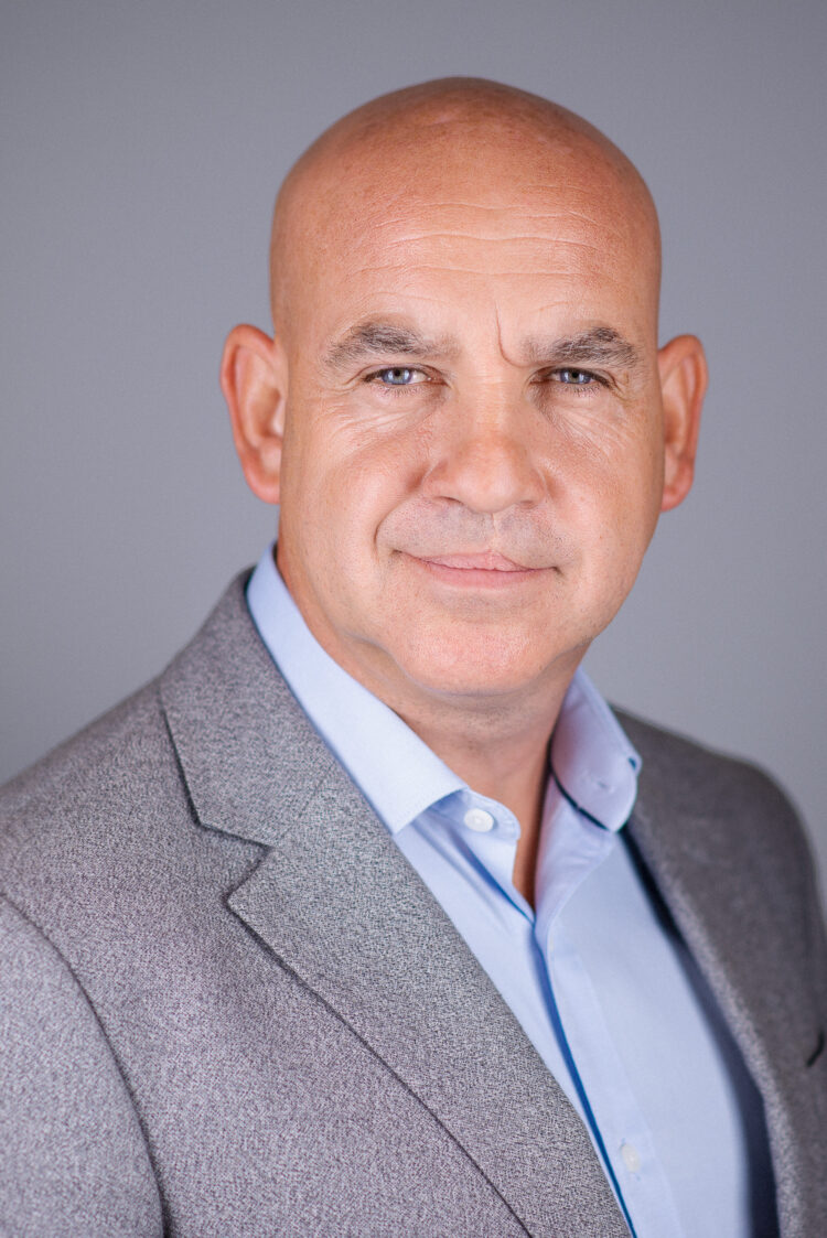 Headshot of bald businessman looking at the camera