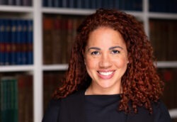 Corporate headshot of black woman smiling at the camera