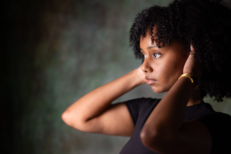 Portrait of black woman holding her afro