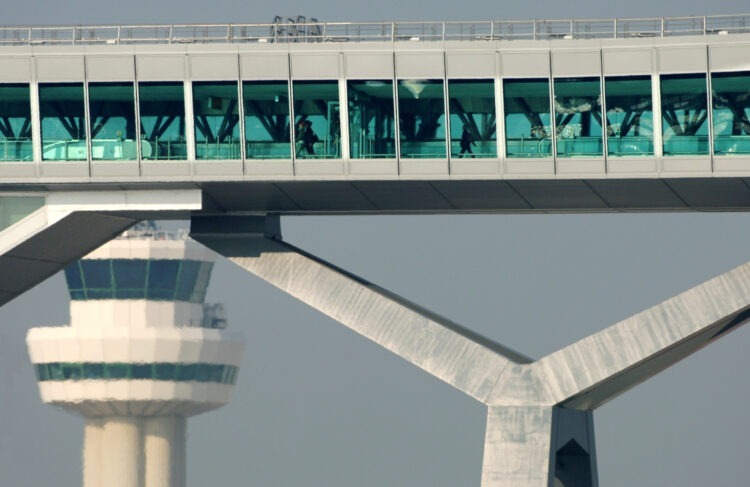 Airport facilities and infrastructure - Pier 6 bridge with control tower in background, London Gatwick