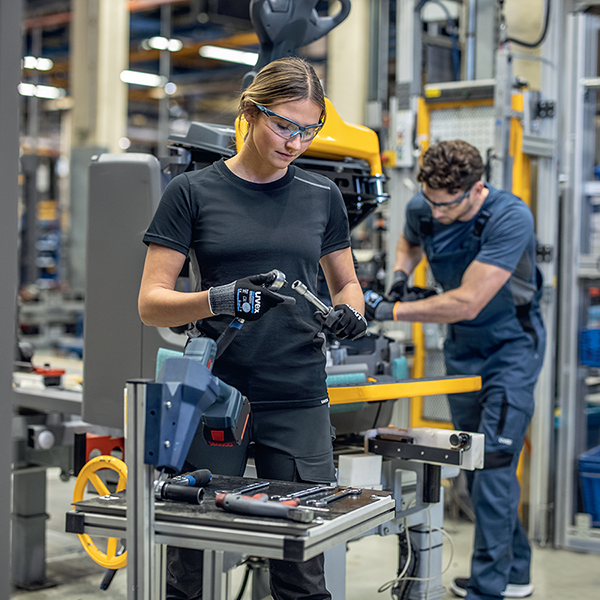 Inclusive PPE. Woman wearing safety eyewear and safety gloves