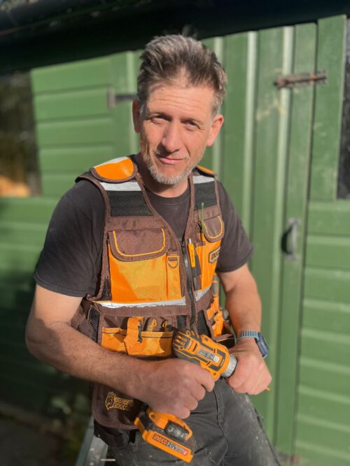 Tradesman on site with an INGCO tools vest and INGCO Drill