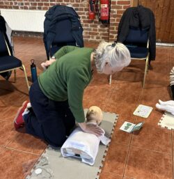 Adult learning CPR on a child.