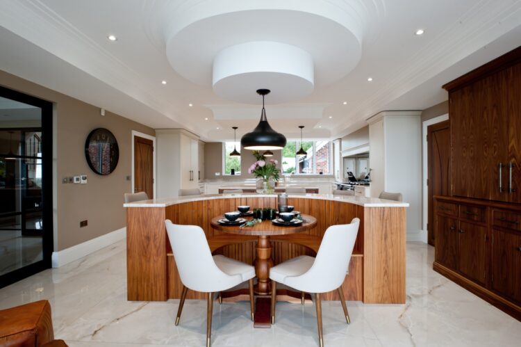 Luxury bespoke kitchen featuring a central island, walnut cabinetry and contemporary pendant lighting, designed and manufactured by Collins Bespoke in Kent.
